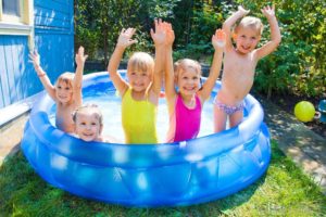 Kids playing in a hard plastic pool